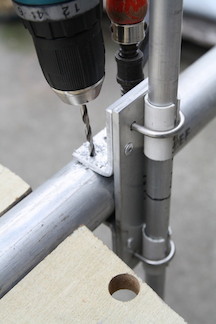 Drilling the rivet hole in the boom. Note the F Clamp at the back holding the assembly in place